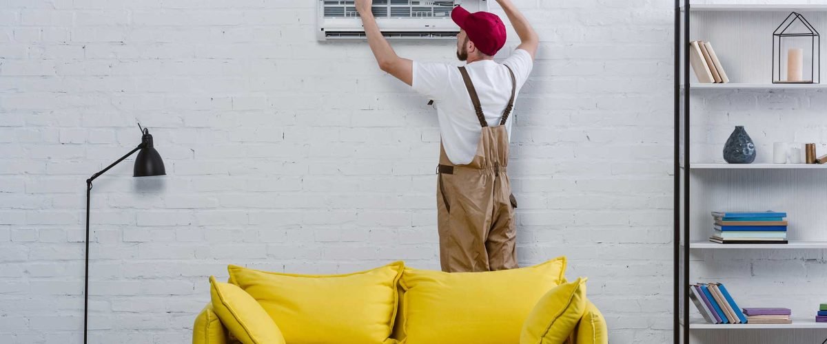 young-professional-repairman-fixing-air-conditione-2022-12-16-20-44-20-utc